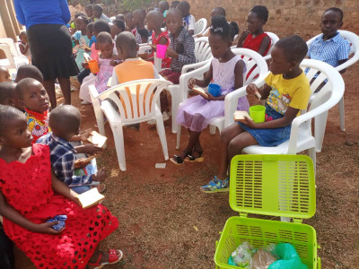 Saving the little children; the little children eating bread